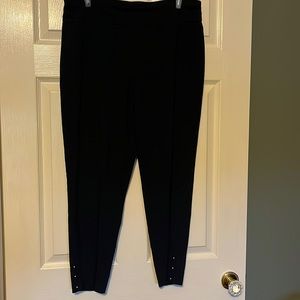 Navy blue stretch slacks with gold studs at ankle.